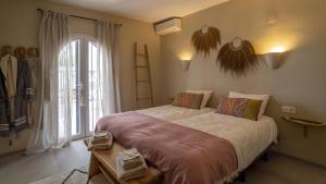 a bedroom with a large bed and a large window at Casa Peponi - By Almarina Villas in Jávea +46 photos