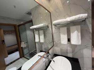 a bathroom with a toilet and a sink and a shower at Zhangjiajie lollipop Hotel in Zhangjiajie