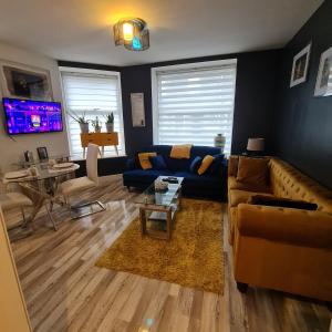 uma sala de estar com um sofá e uma mesa em Charming one bed free parking Aberdeen em Aberdeen