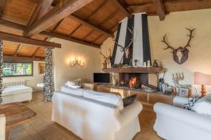 a living room with two white couches and a fireplace at Casale Delle Papere With Private Pool Near Rome in Nepi