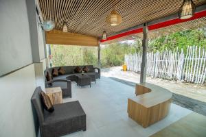 a living room with couches and chairs and a table at Tropical Garden by TANIS in Nusa Lembongan