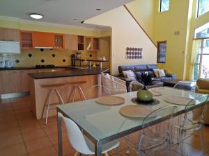 a kitchen and living room with a table and chairs at Amazing Perfect Family Home - GC Beach location in Gold Coast