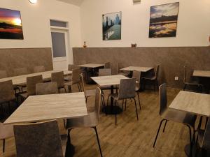 a restaurant with tables and chairs and paintings on the wall at Hotel Zlatá Váha in Prague