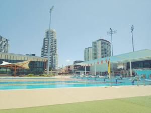 a swimming pool in a city with tall buildings at Amazing Perfect Family Home - GC Beach location in Gold Coast