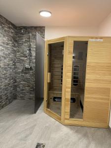 a bathroom with a shower and a wooden cabinet at Kaiserresidenz Ellmau in Ellmau