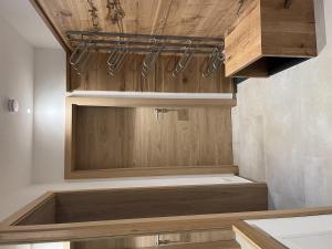 a kitchen with wooden cabinets and a wooden ceiling at Kaiserresidenz Ellmau in Ellmau