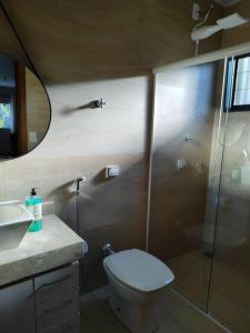 a bathroom with a shower and a toilet and a sink at Casa aconchegante in Sao Jose do Rio Preto