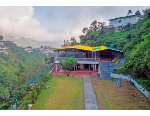 a building with a yellow roof on a hill at Shiv Sutra Resorts, Mussoorie in Mussoorie