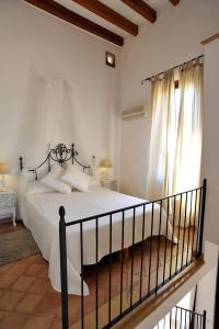 A bed or beds in a room at Petit Hotel Es Figueral
