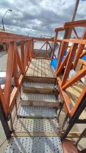 a set of wooden stairs on a bridge at Comodo departamento in Puerto Montt