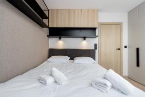 - un grand lit blanc avec 2 oreillers blancs dans l'établissement Bronowice Cosy Apartment, à Cracovie