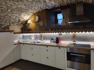 a kitchen with a sink and a stove top oven at Le Petit Château de Vetan CIR 0023 in Saint-Pierre