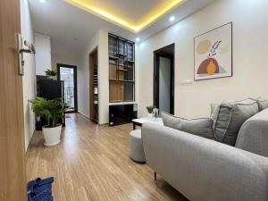 a living room with a couch and a tv at Funhome Apartment Kim Ma Ha Noi in Hanoi
