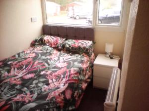 a small bedroom with a bed and a window at country retreat by the sea in Bessingby