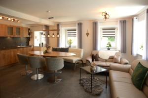 a living room with a couch and a table at Ferienwohnung Holzebenhof in Drachselsried