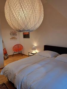 a bedroom with a large bed and a large chandelier at Hotel Union in Offenburg