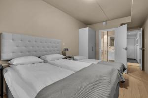 a bedroom with a large bed with a large headboard at City Home Aurora in Tromsø