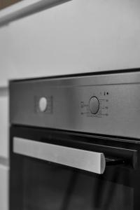 a close up of a microwave oven with a knife at City Home Aurora in Tromsø