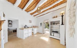 a kitchen with white cabinets and a wooden ceiling at Cortijo El Albaricoque De La Sierra - Finca de 75 Hectáreas ! in Níjar