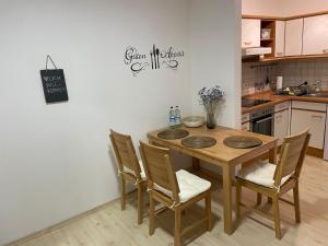 a kitchen with a wooden table and chairs at LovelyDays in Edling