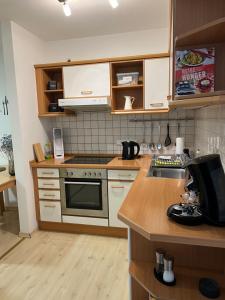 a kitchen with a sink and a stove top oven at LovelyDays in Edling