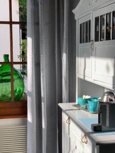 a kitchen with a sink and a window at 'Le Petit Clos Suites'- Charming Garden Villa on Leman Lake in Nyon