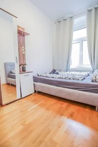 a bedroom with a bed and a large window at Premier Double room TH in Vienna