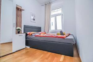 a bedroom with a bed in a room with a window at Premier Double room TH in Vienna