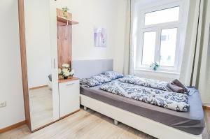 a small bedroom with a bed and a mirror at Premier Double room TH in Vienna