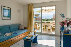 a living room with a couch and a table at Lagrange Vacances Villa Barbara in Cavalaire-sur-Mer