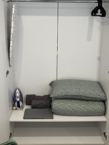 a shelf with two pillows and a laptop on it at Ultra Lux Studio Free Underground Parking in Pazardzhik