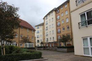 a row of apartment buildings in a courtyard at Cotels at Centro Serviced Apartments in Northampton