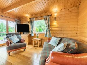 a living room with two couches and a television at Pheasant Lodge Scottish Borders in Carlisle