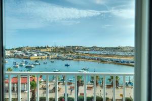 a view of a marina from a balcony at Seafront bright & spacious 2 bedrooms GOGZR-1 in Il-Gżira
