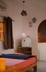 a bedroom with a bed and a television in it at Nook in Dahab