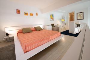 een slaapkamer met een groot bed in een witte kamer bij Casa Bartolomeo - Loft in Trastevere in Rome +10 foto's