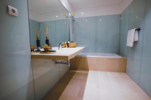 a bathroom with a sink and a shower and a tub at Funchal Centrum Apartment in Funchal