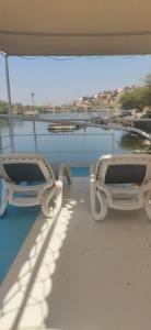 two white benches on the deck of a boat at جزيره سهيل in Cairo