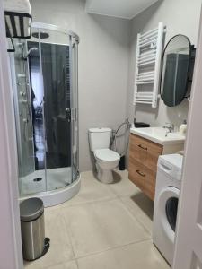 a bathroom with a shower and a toilet and a sink at Luxe et Détente Près du Luxembourg 