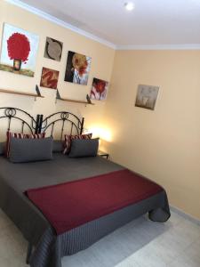 a bedroom with a bed and some pictures on the wall at Vera Natura Urbanización Naturista in Vera