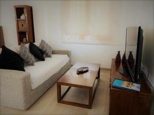 a living room with a couch and a coffee table at Apartamento El Rinconzuelo in Rubielos de Mora