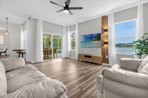 a living room with a couch and a tv at 4 Bathrooms 3 Bathrooms Cresent Lakes 5305 Cv in Kissimmee