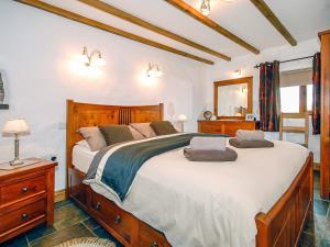 a bedroom with a large bed with two pillows at Beacon Cottage in Llanrian