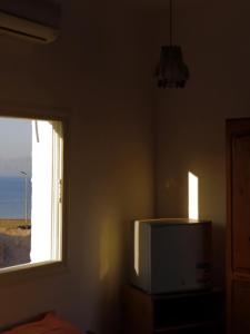 a room with a television and a window at Nook in Dahab