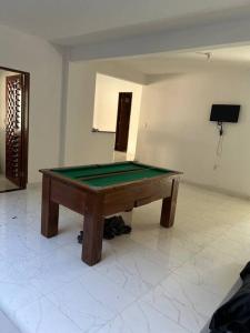 a ping pong table in a room with at Oásis da Praia in Caucaia