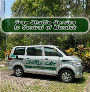 a white suv parked in front of a sign at VILLA IPSA in Munduk