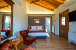 a hotel room with a bed and a chair at Finday Eco Boutique Hotel in Kalavrita