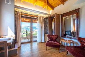 a living room with a couch and a chair and a table at Finday Eco Boutique Hotel in Kalavrita