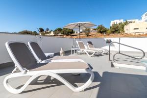 a group of chairs sitting on a roof at Villa Martin in Nerja