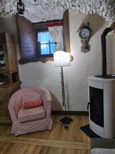 a living room with a chair and a clock at Le Petit Château de Vetan CIR 0023 in Saint-Pierre